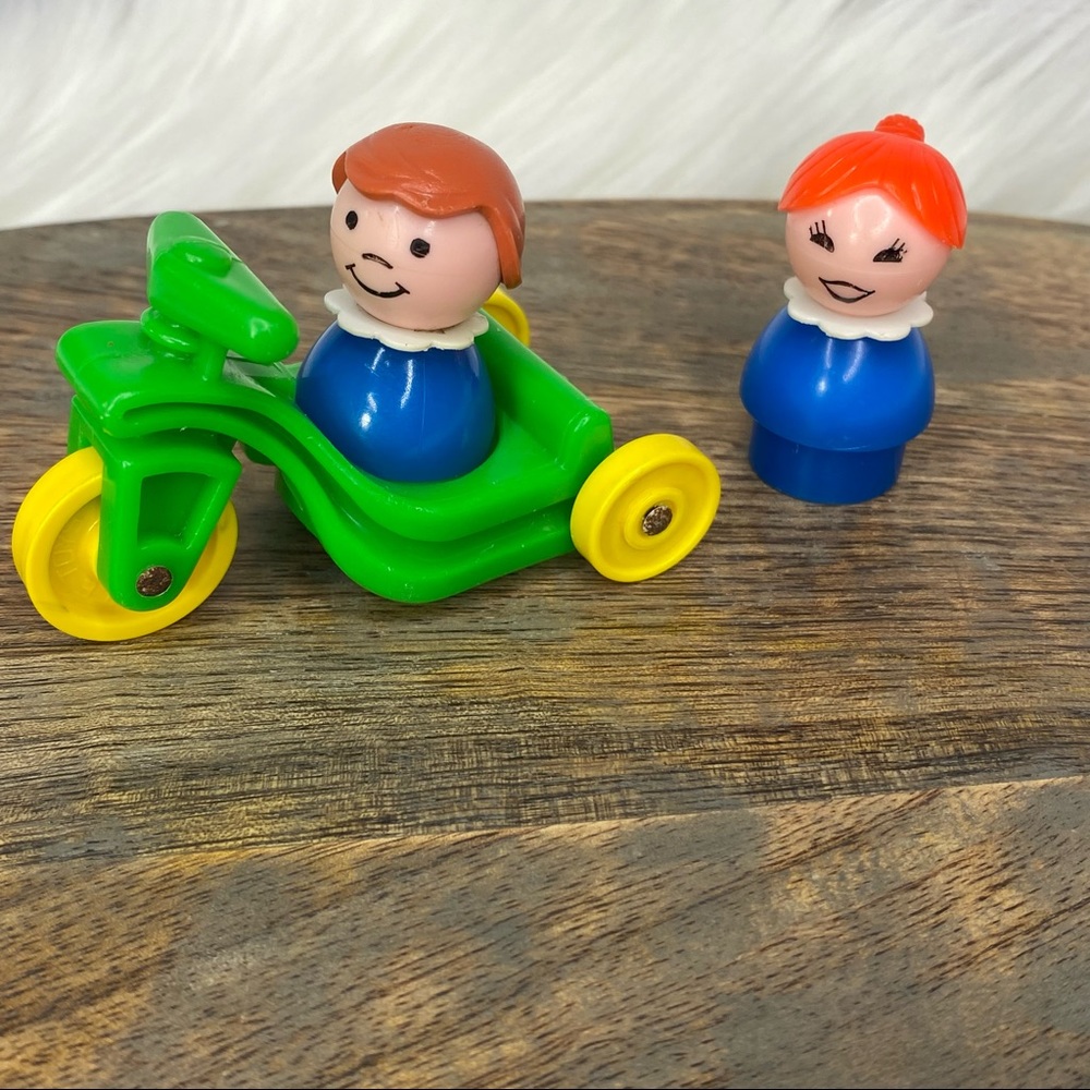 Little People girl riding green trike